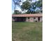 The backyard features a large lawn and a screened patio at 3400 Ne 43Rd Pl, Ocala, FL 34479