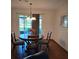 Cozy dining area with hardwood floors and sliding doors to backyard at 3400 Ne 43Rd Pl, Ocala, FL 34479