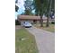 A lovely single-story home with a long driveway and attached garage at 3400 Ne 43Rd Pl, Ocala, FL 34479