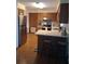 Well-lit kitchen with stainless steel appliances, wood cabinets, and breakfast bar at 3400 Ne 43Rd Pl, Ocala, FL 34479