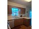 Cozy kitchen features wood cabinets, laminate countertops, and stainless steel dishwasher at 3400 Ne 43Rd Pl, Ocala, FL 34479