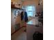 Functional laundry room with washer, dryer, shelving, and storage space at 3400 Ne 43Rd Pl, Ocala, FL 34479