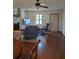 Bright living room with hardwood floors, fireplace, and ceiling fan at 3400 Ne 43Rd Pl, Ocala, FL 34479