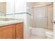 Clean bathroom with updated vanity, bath tub and shower with glass doors at 505 Millifiora Ln, Kissimmee, FL 34759