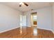 Spacious bedroom features laminate flooring, a ceiling fan, neutral paint, and an ensuite bathroom at 505 Millifiora Ln, Kissimmee, FL 34759