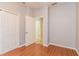 Bright bedroom with wood floors, closet and entry to the attached bathroom at 505 Millifiora Ln, Kissimmee, FL 34759