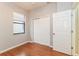 Neutral color bedroom with laminate flooring, closet, and window with bright white trim at 505 Millifiora Ln, Kissimmee, FL 34759