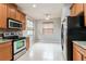 Kitchen boasts stainless steel appliances, wooden cabinets, and granite countertops at 505 Millifiora Ln, Kissimmee, FL 34759