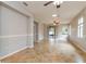 Spacious living room featuring neutral walls, tile flooring, ceiling fans, and natural lighting at 505 Millifiora Ln, Kissimmee, FL 34759