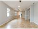 Bright living room with tile floors, a ceiling fan, and large windows with a bright neutral color at 505 Millifiora Ln, Kissimmee, FL 34759