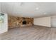 Spacious basement featuring wood flooring and a striking stone fireplace feature at 803 Mccranie Rd, Lakeland, FL 33809