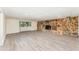 Basement with stylish wood flooring and cozy stone fireplace for relaxation at 803 Mccranie Rd, Lakeland, FL 33809