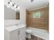Charming bathroom with white vanity, tub and modern fixtures offering comfort at 803 Mccranie Rd, Lakeland, FL 33809