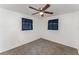 Bright carpeted bedroom featuring ceiling fan and two windows offers functionality at 803 Mccranie Rd, Lakeland, FL 33809