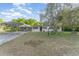 Charming single-story home featuring a covered carport, a well-maintained lawn, and mature trees at 803 Mccranie Rd, Lakeland, FL 33809