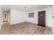 Inviting living room featuring wood-look flooring, a decorative front door, and neutral-toned walls at 803 Mccranie Rd, Lakeland, FL 33809