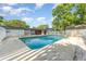 Backyard swimming pool enclosed by white fence in grassy, partially wooded yard at 803 Mccranie Rd, Lakeland, FL 33809