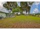 Spacious backyard featuring mature trees with Spanish moss, green grass, and serene country views at 9210 Lehall W Sq, Lakeland, FL 33810