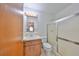 Modest bathroom with linoleum flooring, a standard toilet, a small sink, and a glass shower at 9210 Lehall W Sq, Lakeland, FL 33810