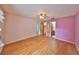 Bright bedroom features wood flooring, closet access, and an ensuite bathroom at 9210 Lehall W Sq, Lakeland, FL 33810