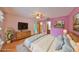 Staged bedroom featuring a large bed, dresser, and access to the ensuite bathroom at 9210 Lehall W Sq, Lakeland, FL 33810