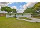 Charming single-story home with a well-manicured lawn, walkway, and attached garage at 9210 Lehall W Sq, Lakeland, FL 33810