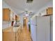Well-lit kitchen features wood cabinetry, laminate flooring, and a convenient layout at 9210 Lehall W Sq, Lakeland, FL 33810
