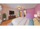Spacious main bedroom with laminate flooring, ceiling fan, and ensuite bathroom at 9210 Lehall W Sq, Lakeland, FL 33810