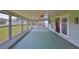Sunroom overlooking backyard with ample natural light, ceiling fan, and access to kitchen at 9210 Lehall W Sq, Lakeland, FL 33810