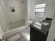 Bathroom featuring shower/tub combination, dark granite vanity and tile backsplash at 990 Keen Rd, Frostproof, FL 33843
