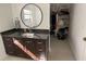 Bathroom vanity with dark granite countertop, storage and mirror at 990 Keen Rd, Frostproof, FL 33843