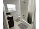 Bathroom featuring tub/shower combination, dark granite vanity, tile floors and a large window at 990 Keen Rd, Frostproof, FL 33843