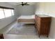 Bedroom featuring light bed frame, grey rug, dark dresser and neutral walls at 990 Keen Rd, Frostproof, FL 33843