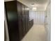 Hallway featuring custom cabinetry and neutral tile flooring at 990 Keen Rd, Frostproof, FL 33843