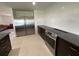 Kitchen featuring stainless steel refrigerator, matching oven, dark cabinets and bright white backsplash at 990 Keen Rd, Frostproof, FL 33843