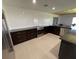 A contemporary kitchen with stainless steel appliances and dark cabinets with white subway tile backsplash at 990 Keen Rd, Frostproof, FL 33843