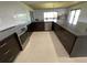 Bright kitchen featuring dark cabinetry, stainless steel appliances, white tile backsplash and breakfast bar seating at 990 Keen Rd, Frostproof, FL 33843