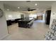Spacious kitchen with central island, stainless steel appliances, and seamless connection to dining area at 990 Keen Rd, Frostproof, FL 33843