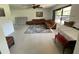 Inviting living room featuring a comfortable leather sofa and area rug at 990 Keen Rd, Frostproof, FL 33843