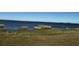 Picturesque view of calm lake waters surrounded by natural vegetation at 990 Keen Rd, Frostproof, FL 33843