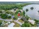Aerial view of home near a lake surrounded by lush greenery, showcasing its waterfront community and location at 4912 Marla Ave, Lakeland, FL 33812