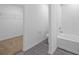 A pristine bathroom offers a bathtub with white tiles, and a glimpse into the walk-in closet at 2214 Pecos Ct, Poinciana, FL 34759