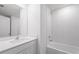 Bright bathroom includes a vanity, large mirror and tiled tub/shower at 2214 Pecos Ct, Poinciana, FL 34759