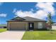 Charming single-story home with a well-manicured lawn and inviting front entrance at 2214 Pecos Ct, Poinciana, FL 34759