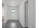 Foyer with glass front door and gray wood flooring at 2214 Pecos Ct, Poinciana, FL 34759