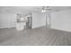 Open floorplan with gray wood floors connecting living area and kitchen with island at 2214 Pecos Ct, Poinciana, FL 34759