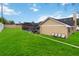 Expansive backyard with lush green lawn, screened-in pool, and patio at 4014 Gallagher Loop, Casselberry, FL 32707