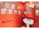 Quaint half-bathroom with a small basin and bright red walls at 4014 Gallagher Loop, Casselberry, FL 32707