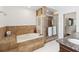 A beautifully tiled bathroom featuring a soaking tub and glass-enclosed shower at 4014 Gallagher Loop, Casselberry, FL 32707