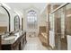 Luxurious bathroom with double vanity, walk-in shower, soaking tub, and large window at 4014 Gallagher Loop, Casselberry, FL 32707